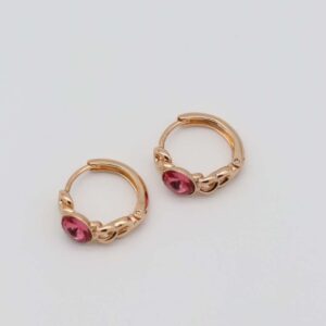 Gold-plated hoop earrings with intricate chain details and bold pink gemstone centers, displayed on a neutral background.