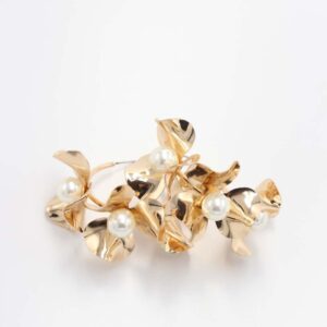 A Rhodium plating floral statement ring adorned with small pearls, showcasing an elegant and modern design on a white background.