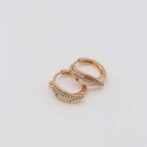 Gold-plated hoop earrings with an elegant curve design and sparkling crystal embellishments, set against a plain white background.