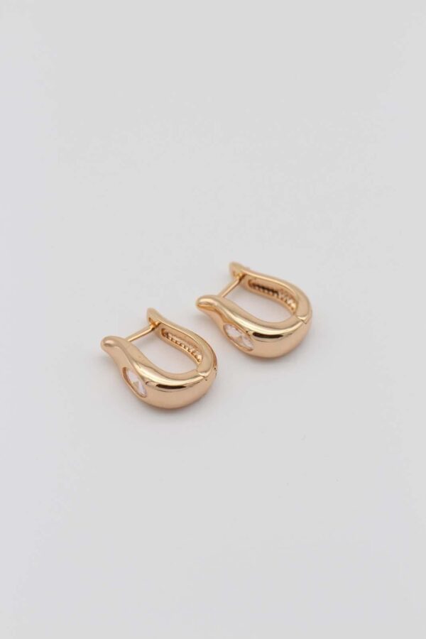 Elegant gold-plated hoop earrings with a smooth, modern silhouette and sparkling crystal accents, displayed against a neutral background.