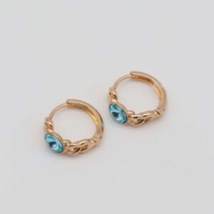 Gold-plated hoop earrings with intricate chain details and bold aqua gemstone centers, displayed on a neutral background.