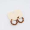 Wild Elegance Hoop Earrings with brown resin, leopard-print accents, and gold-plated details.