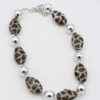 Silver Leopard Print Necklace with alternating silver and leopard-patterned geometric beads.