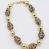 Gold Leopard Print Necklace with geometric leopard-patterned and gold beads.