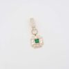 Gold square pendant with green gemstone and crystal embellishments