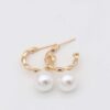 Gold textured hoop earrings with pearl accent
