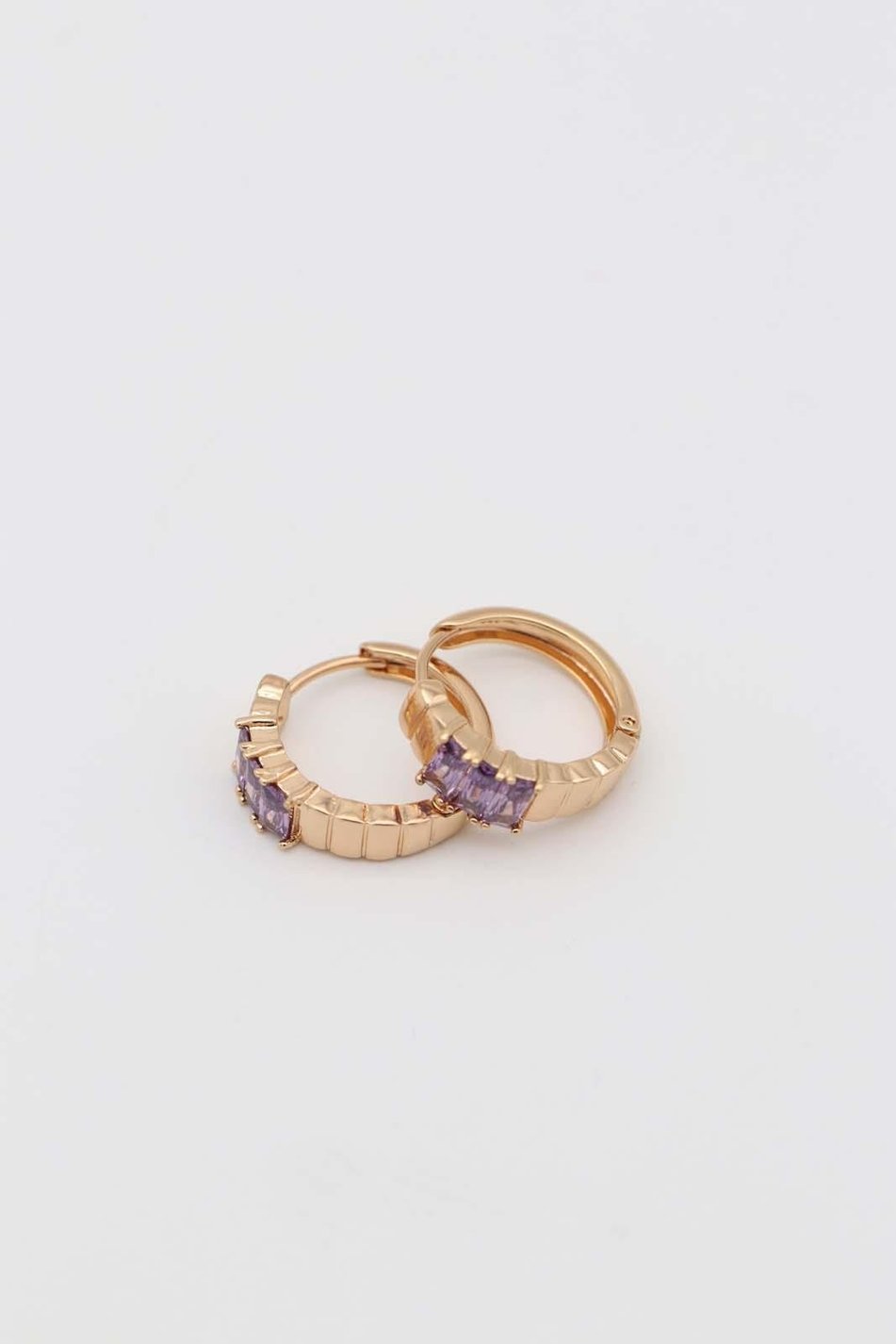 Gold hoop earrings with lavender cubic zirconia stones