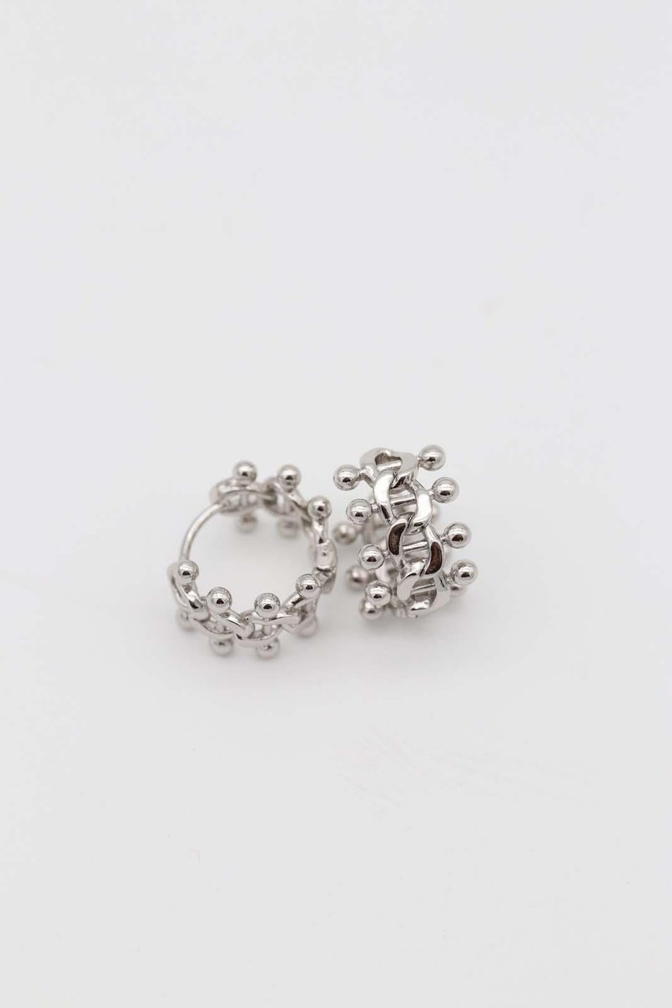 Intricate silver crown-style hoop earrings
