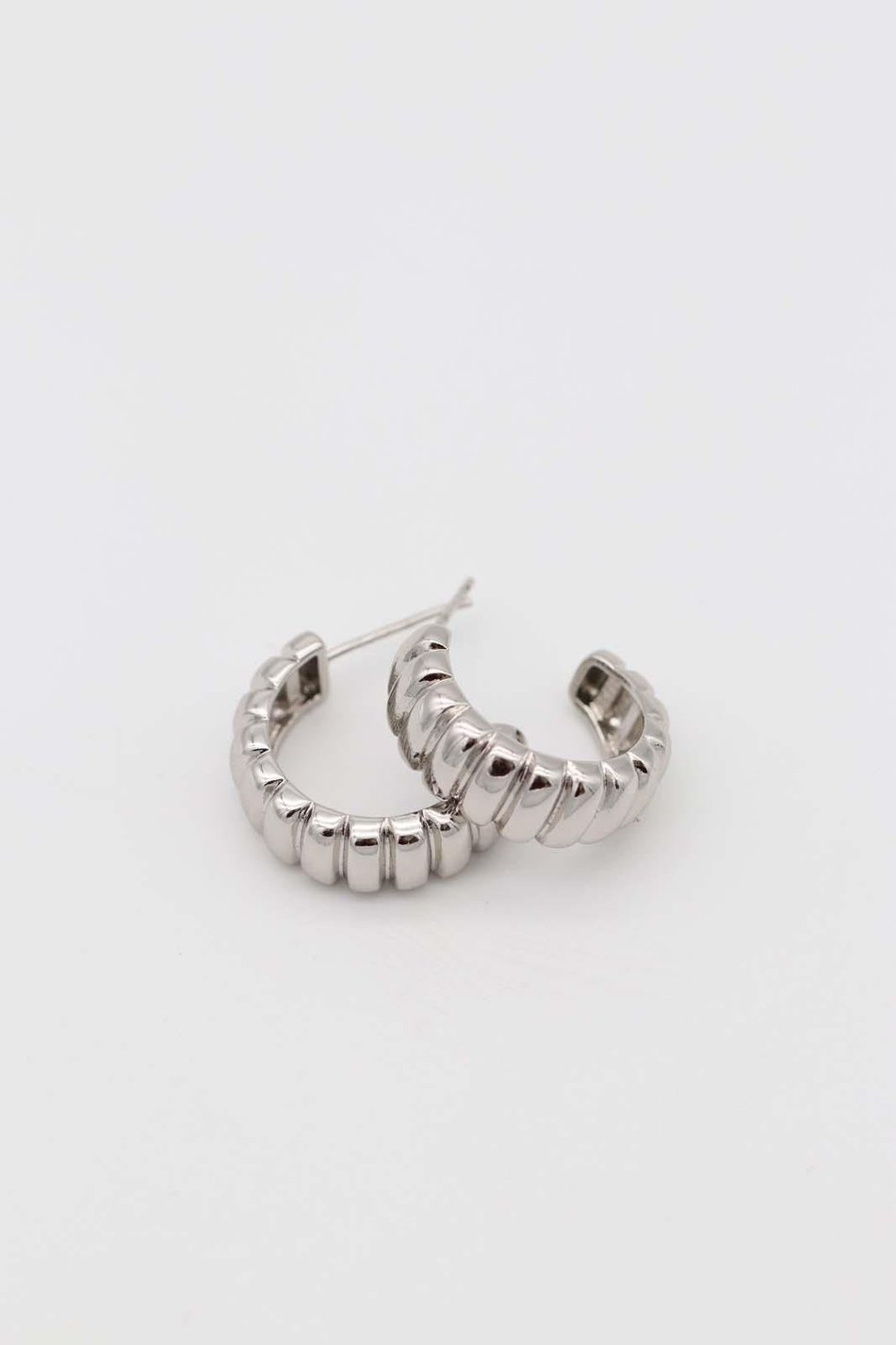 Silver sculpted hoop earrings with bold ridges